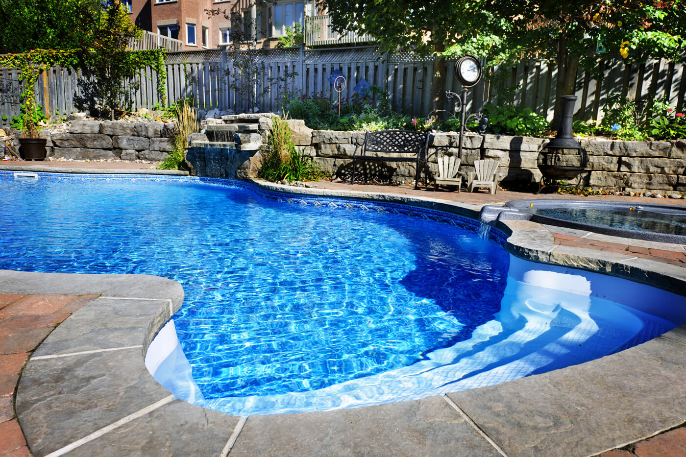 Large vinyl lined inground pool and outdoor living renovation by Seaway's custom pool builders and landscape designers.