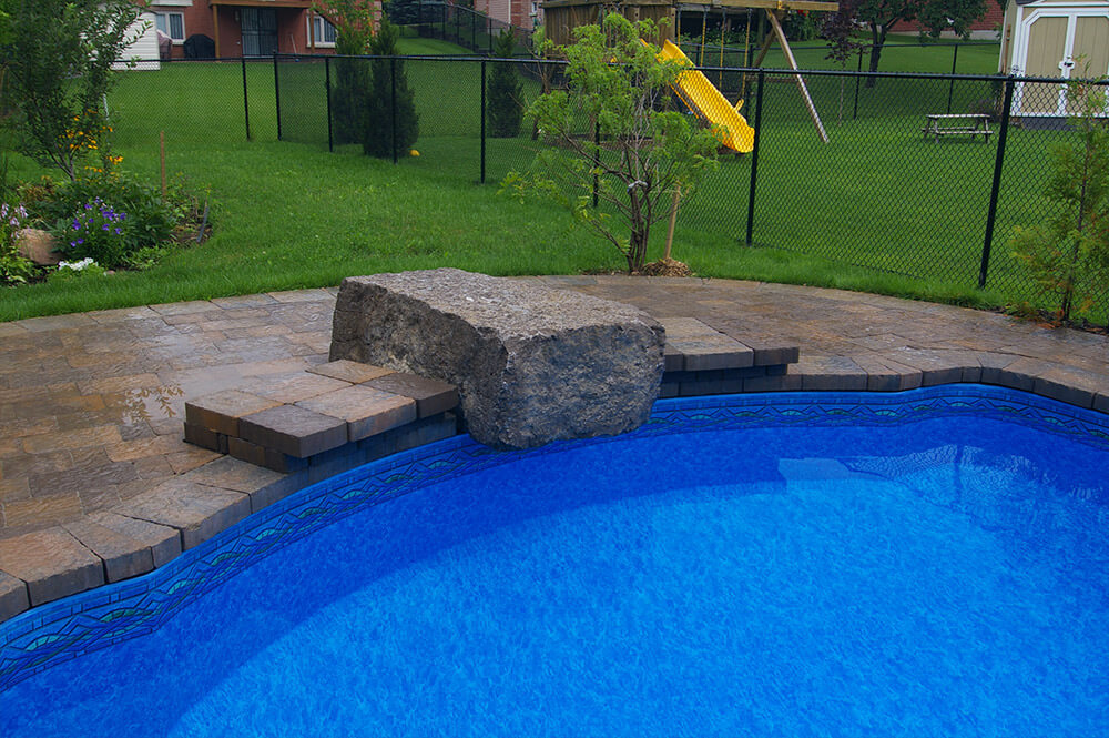 Stone bench installed with interlocking stonework by Seaway Pools & Hot Tubs