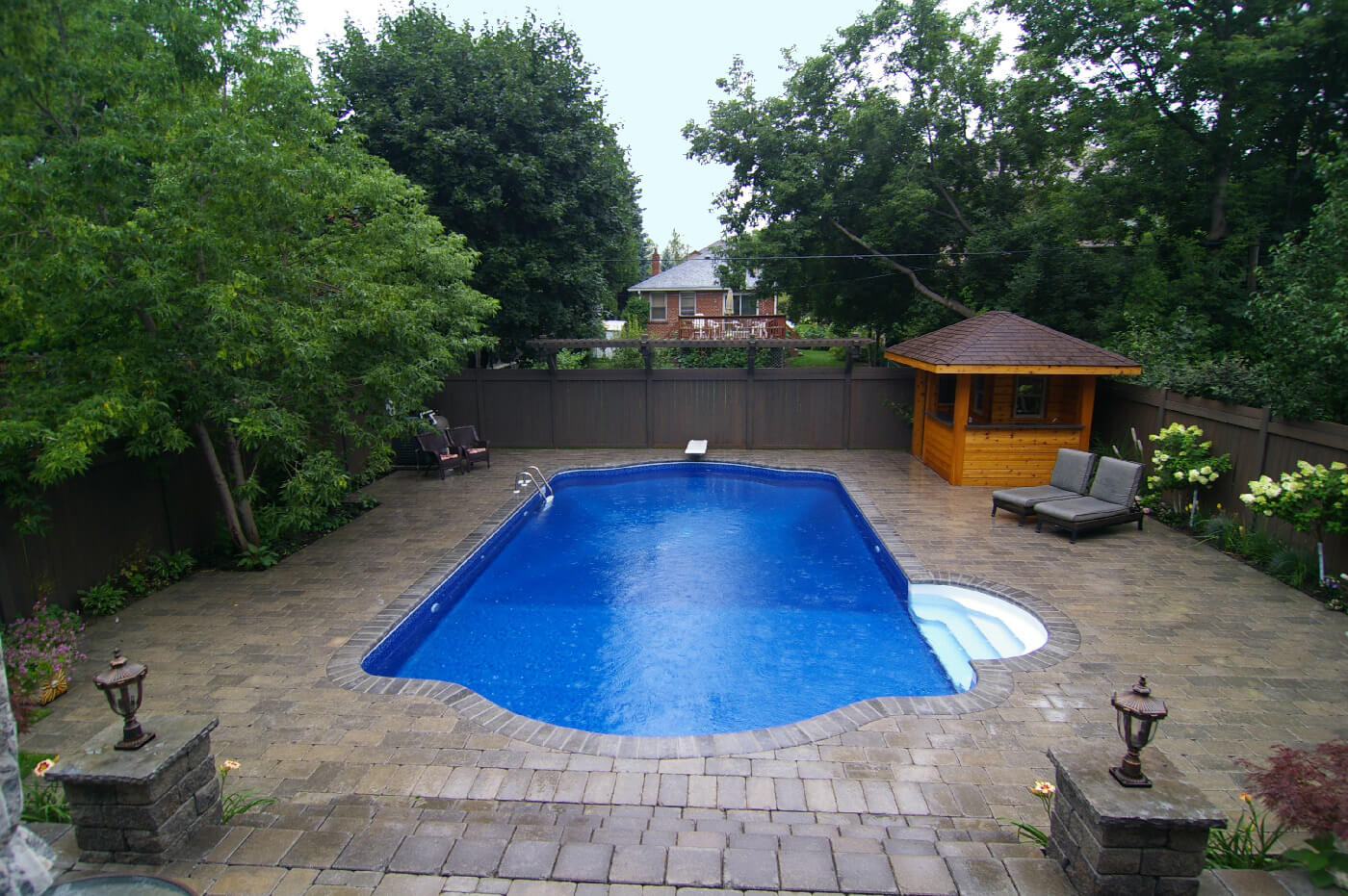 Beautiful inground pool installed with interlock landscaping built by Seaway Pools & Hot Tubs contractors.