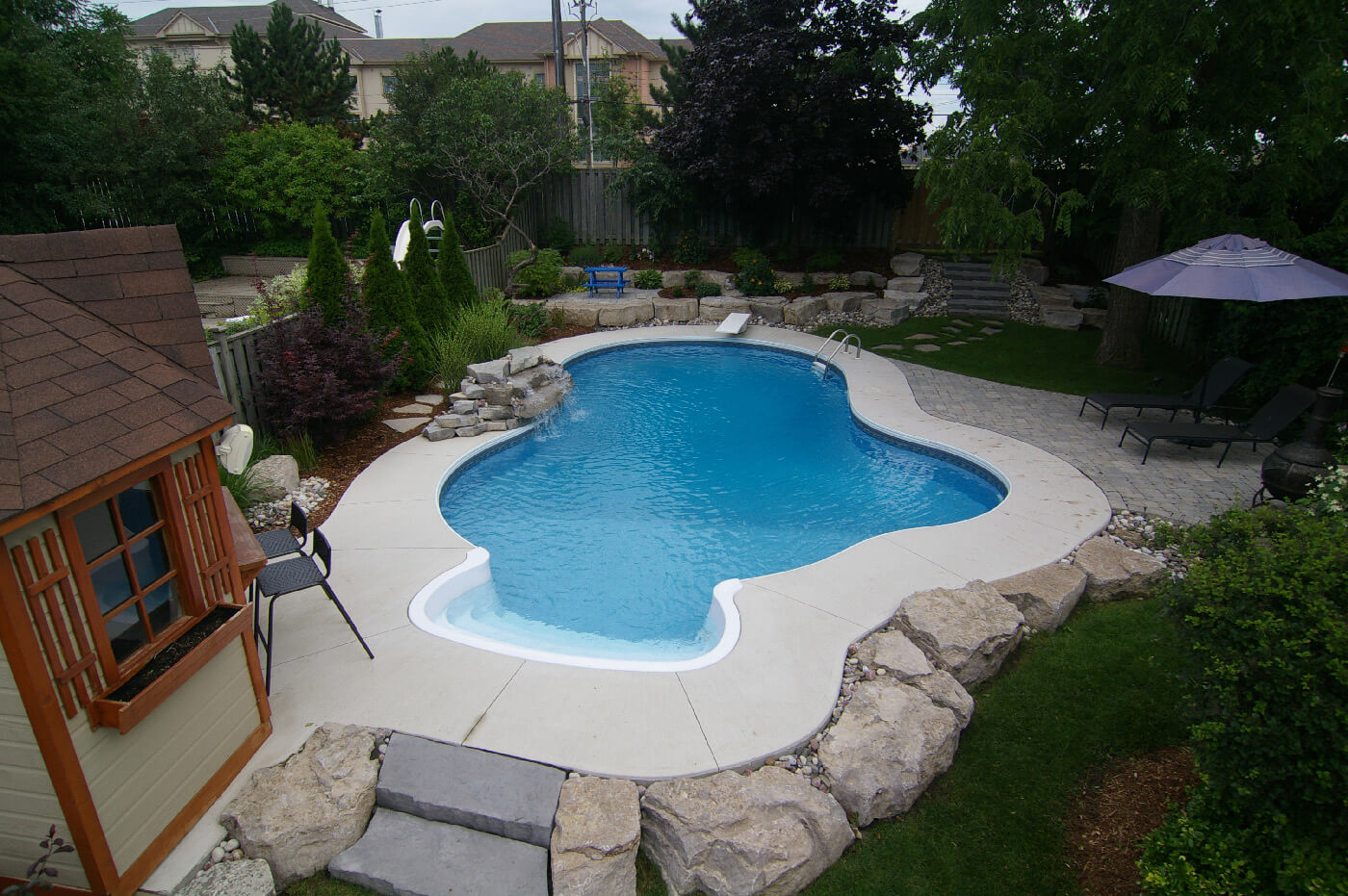 Small yard swimming pool designed by Seaway's custom pool designers & builders.