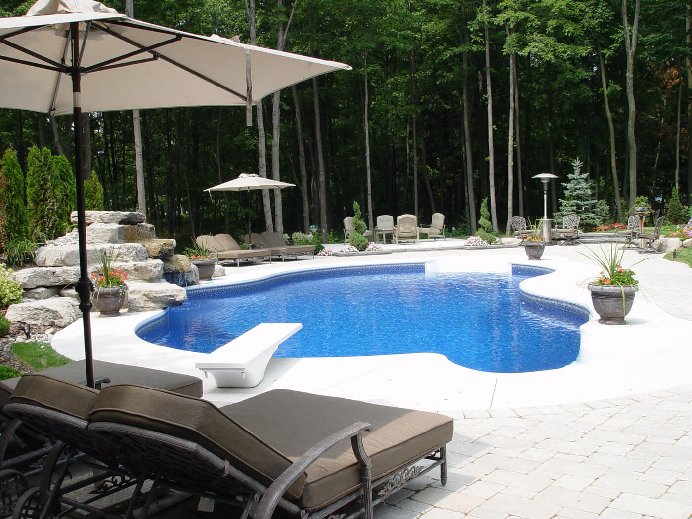 Backyard renovation with swimming pool, pool accessories, diving board and outdoor living furniture & accessories, built & sourced from Seaway Pools